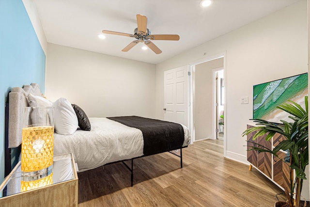 bedroom with ceiling fan and light hardwood / wood-style flooring