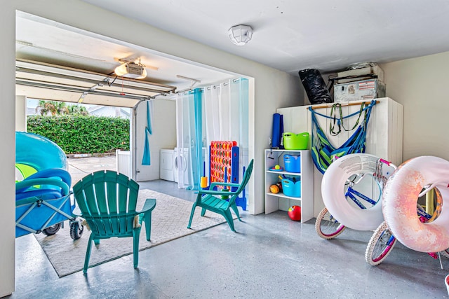 garage featuring independent washer and dryer and a garage door opener