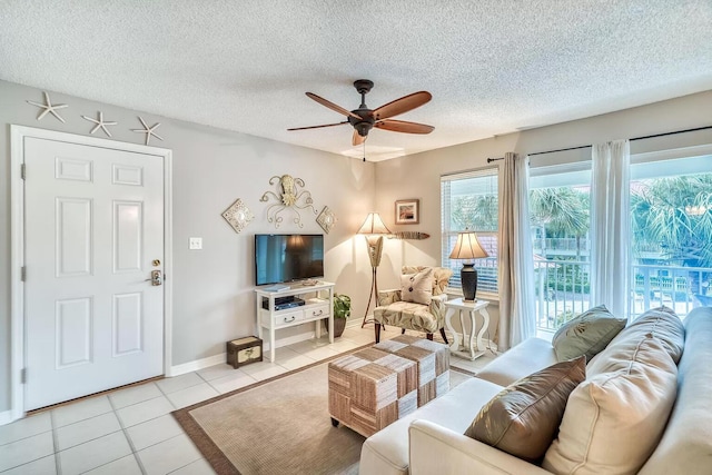 tiled living room featuring ceiling fan and a textured ceiling