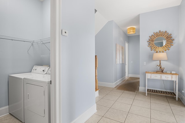 laundry area with washer and dryer and light tile patterned floors