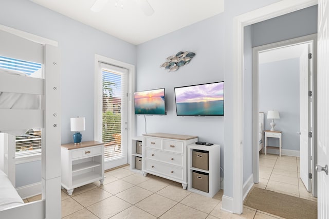 tiled bedroom with ceiling fan and access to exterior