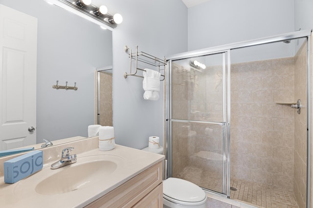 bathroom with walk in shower, vanity, and toilet