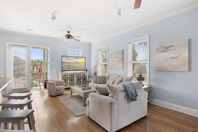 living room with crown molding, ceiling fan, and hardwood / wood-style flooring