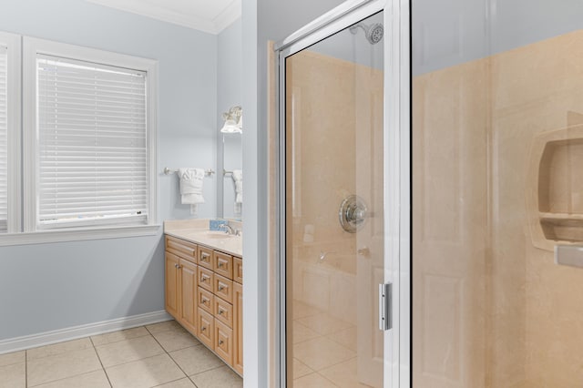 bathroom with ornamental molding, a shower with shower door, tile patterned flooring, and vanity