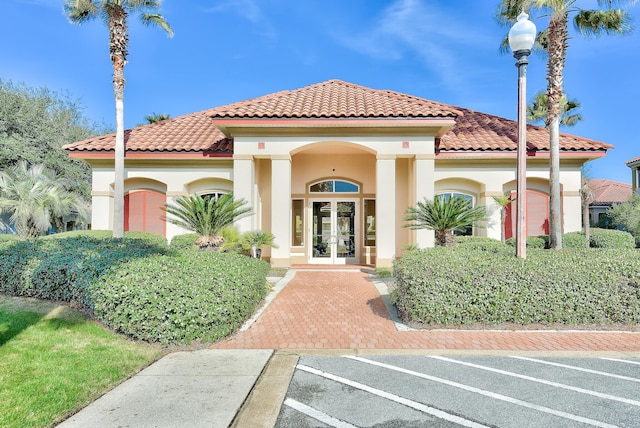 mediterranean / spanish-style house with french doors and a garage