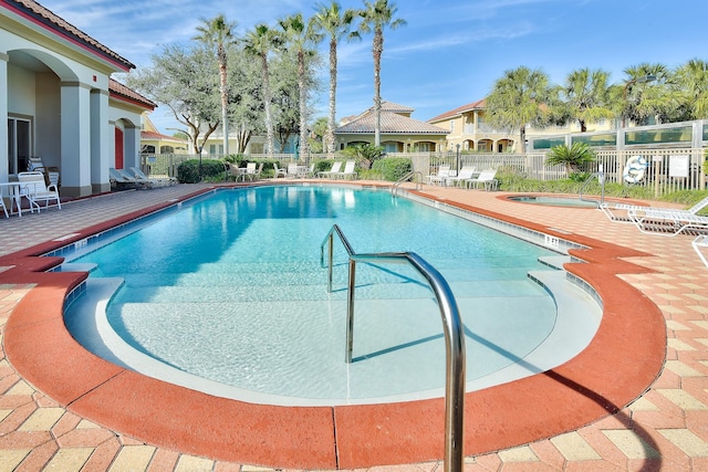 view of pool featuring a hot tub and a patio