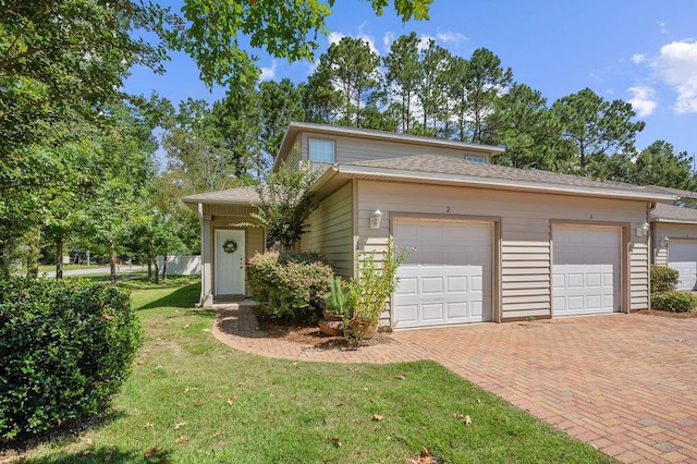 view of front of property featuring a garage and a front lawn