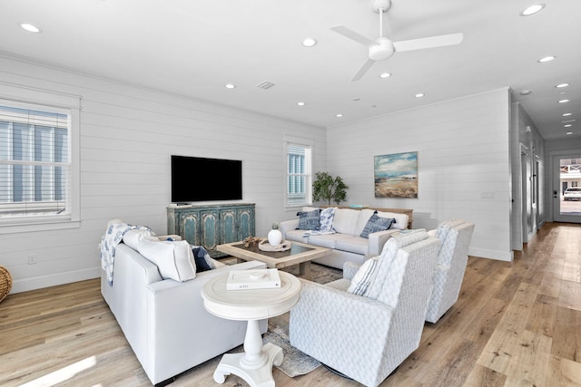 living room featuring ceiling fan and light hardwood / wood-style floors