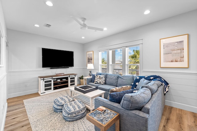 living room with light wood-type flooring and ceiling fan