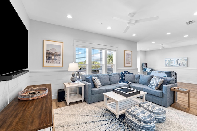 living room with hardwood / wood-style floors and ceiling fan