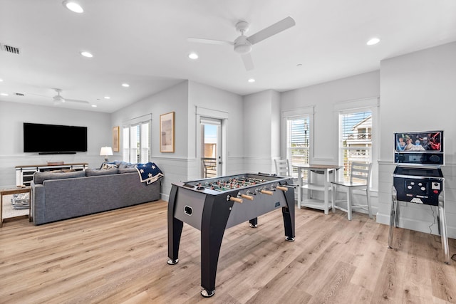 game room with ceiling fan and light wood-type flooring