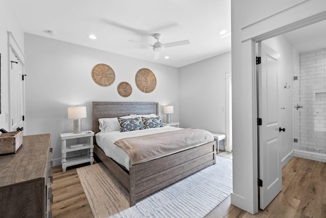 bedroom with ceiling fan, ensuite bathroom, and hardwood / wood-style flooring