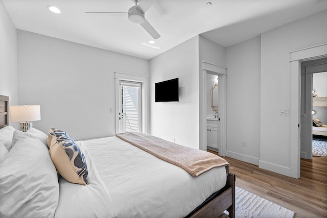 bedroom featuring ceiling fan, ensuite bathroom, and hardwood / wood-style flooring