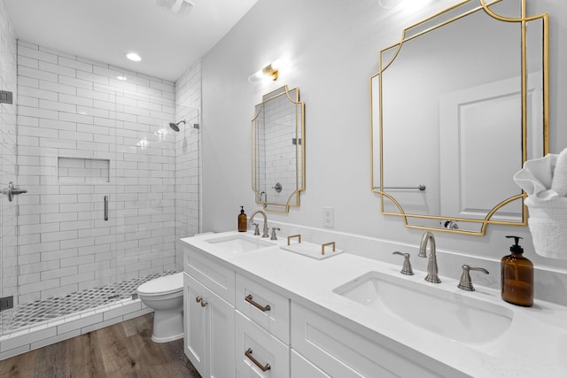 bathroom with toilet, wood-type flooring, an enclosed shower, and vanity