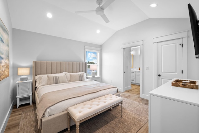 bedroom featuring lofted ceiling, ensuite bathroom, ceiling fan, and light hardwood / wood-style flooring