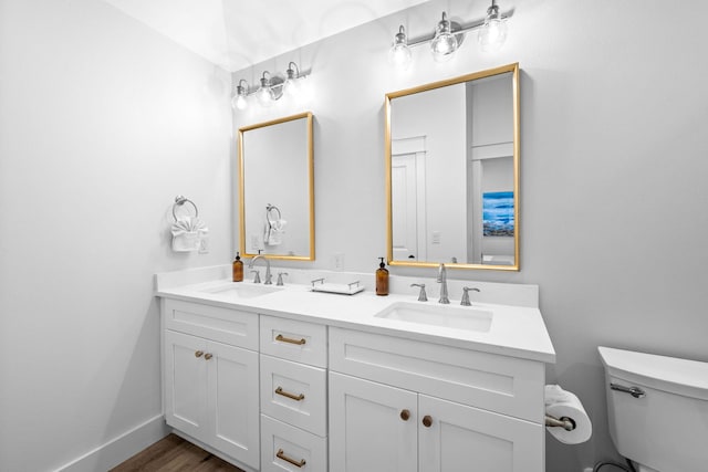 bathroom featuring toilet, hardwood / wood-style flooring, and vanity