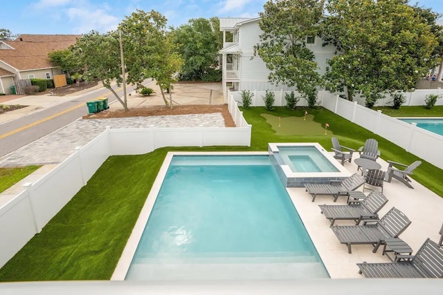 view of pool with an in ground hot tub and a patio