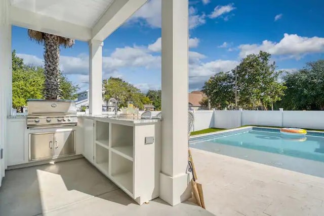 view of patio / terrace featuring a fenced in pool and area for grilling