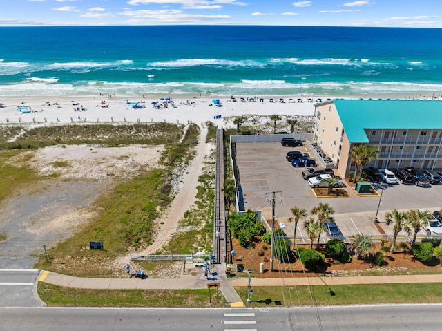 drone / aerial view featuring a beach view and a water view