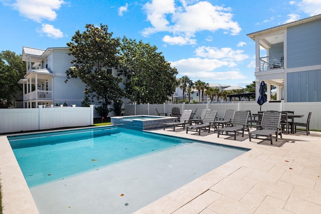 view of swimming pool with a patio area and an in ground hot tub