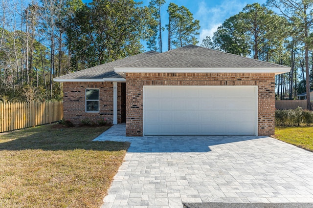 ranch-style home featuring a garage and a front lawn