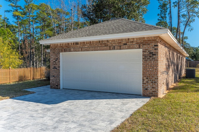 garage featuring cooling unit and a lawn