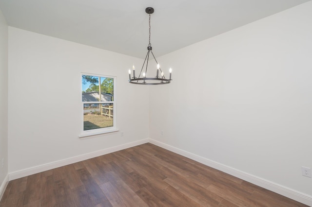 unfurnished dining area featuring dark hardwood / wood-style floors and a notable chandelier