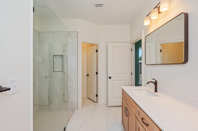 bathroom featuring a shower with door and vanity