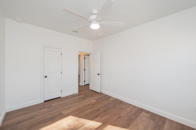 spare room featuring ceiling fan and dark hardwood / wood-style floors