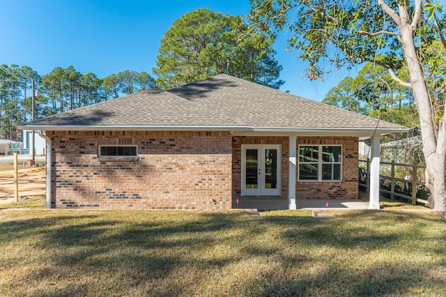 rear view of property featuring a patio area, french doors, and a lawn