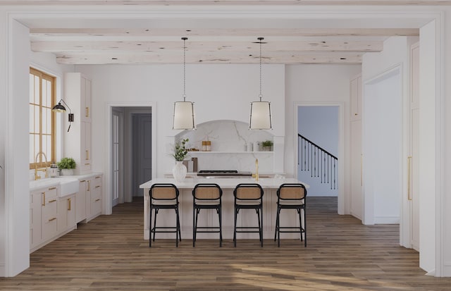 kitchen featuring decorative light fixtures, sink, dark wood-type flooring, a breakfast bar, and beamed ceiling