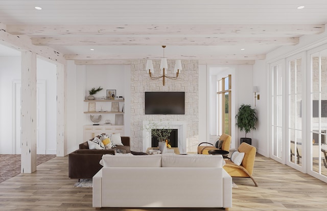 living room featuring light wood-type flooring, beamed ceiling, a notable chandelier, and a fireplace