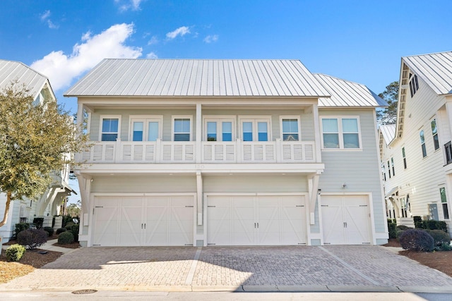 view of front of property with a balcony and a garage