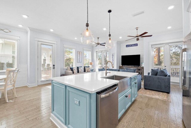 kitchen featuring a kitchen island with sink, blue cabinetry, light wood-type flooring, pendant lighting, and stainless steel dishwasher