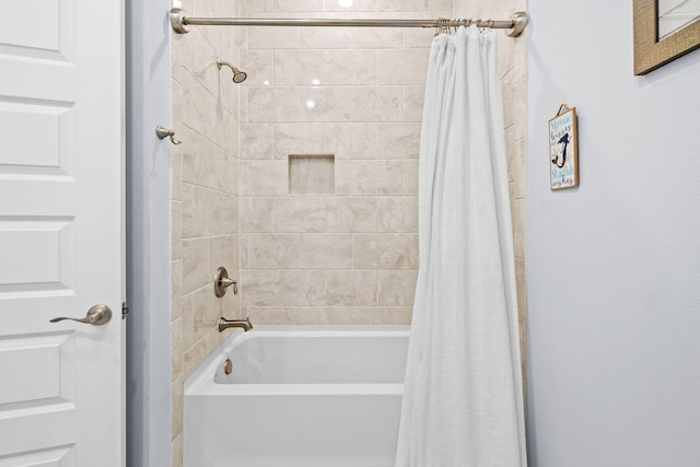 bathroom with shower / bath combo with shower curtain