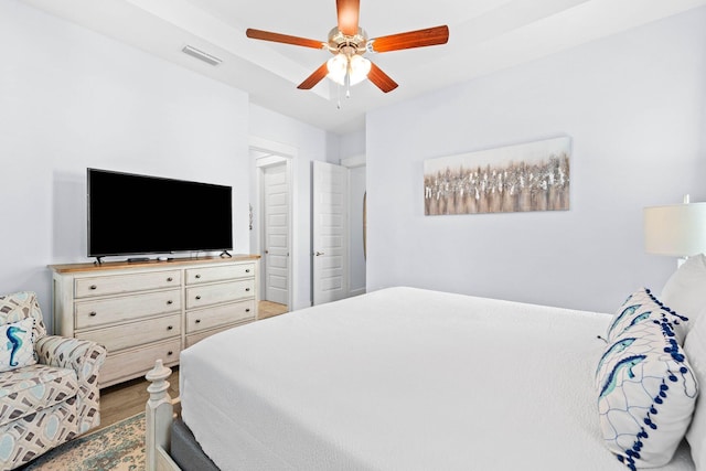 bedroom with ceiling fan and hardwood / wood-style floors