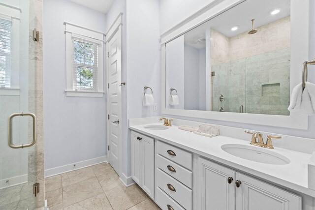 bathroom with a shower with shower door and vanity