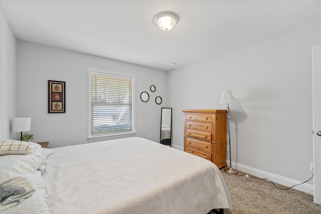 carpeted bedroom featuring baseboards