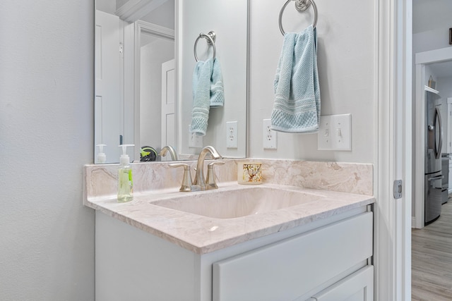 bathroom with vanity and wood finished floors