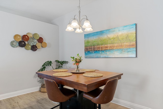 dining room with an inviting chandelier, wood finished floors, and baseboards