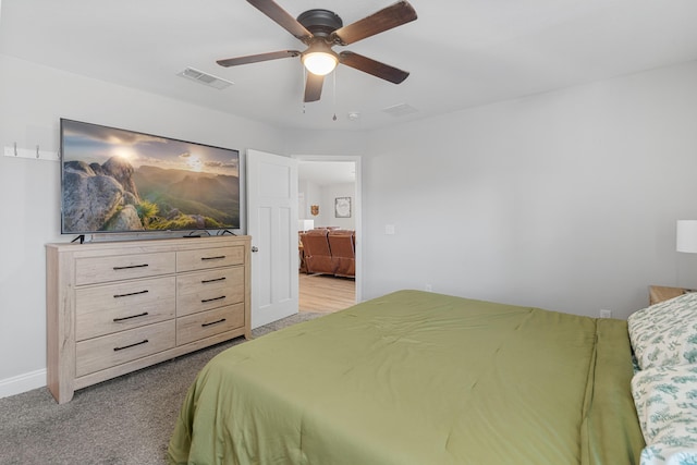 bedroom featuring visible vents, ceiling fan, and light carpet