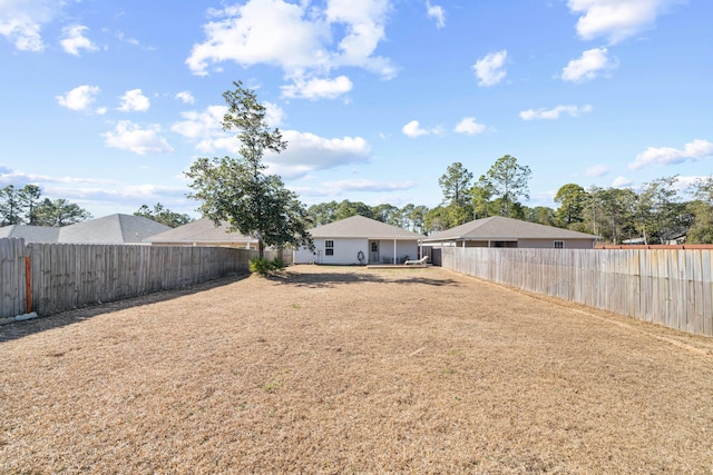 view of yard with a fenced backyard