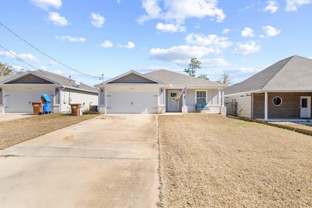 ranch-style home featuring a garage, driveway, a shingled roof, and a front yard