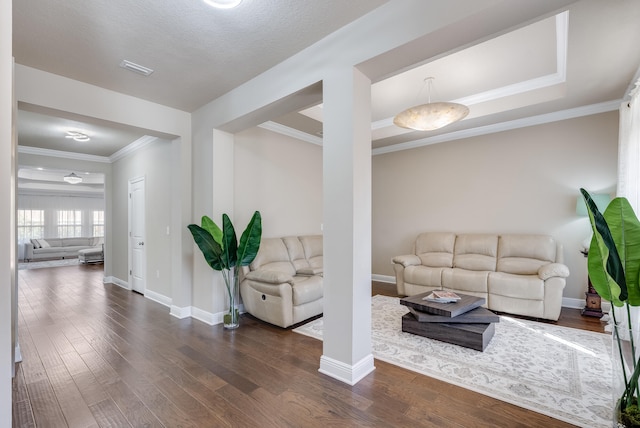 living room with dark wood-type flooring and ornamental molding