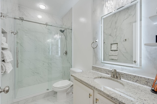 bathroom featuring a shower with shower door, toilet, and vanity