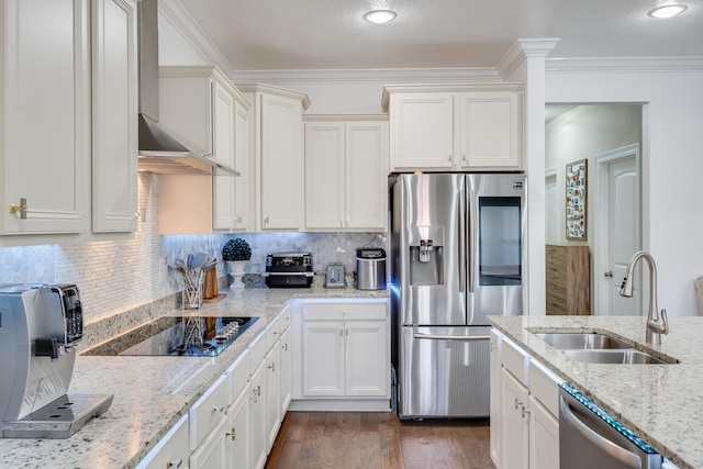 kitchen with appliances with stainless steel finishes, decorative backsplash, light stone countertops, wall chimney exhaust hood, and sink