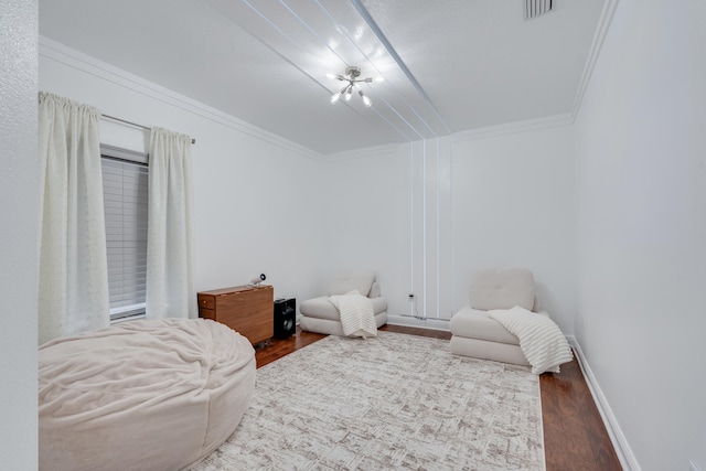 bedroom featuring hardwood / wood-style flooring and crown molding