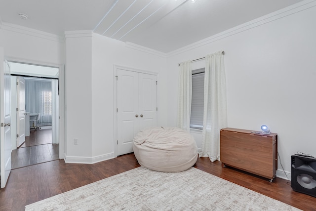 sitting room with dark wood-type flooring and ornamental molding