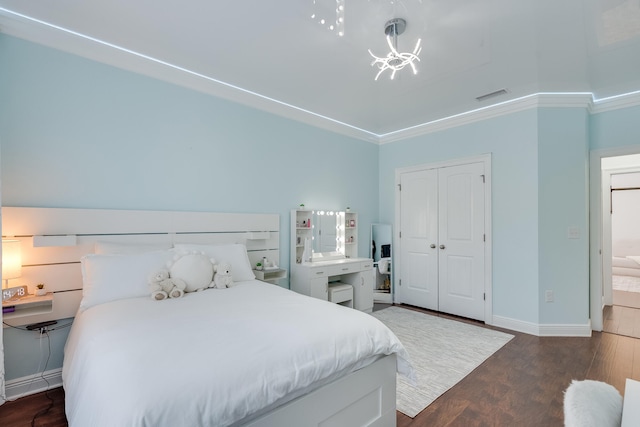 bedroom featuring a closet, ornamental molding, and dark hardwood / wood-style floors