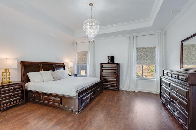 bedroom with an inviting chandelier, dark hardwood / wood-style flooring, crown molding, and a raised ceiling